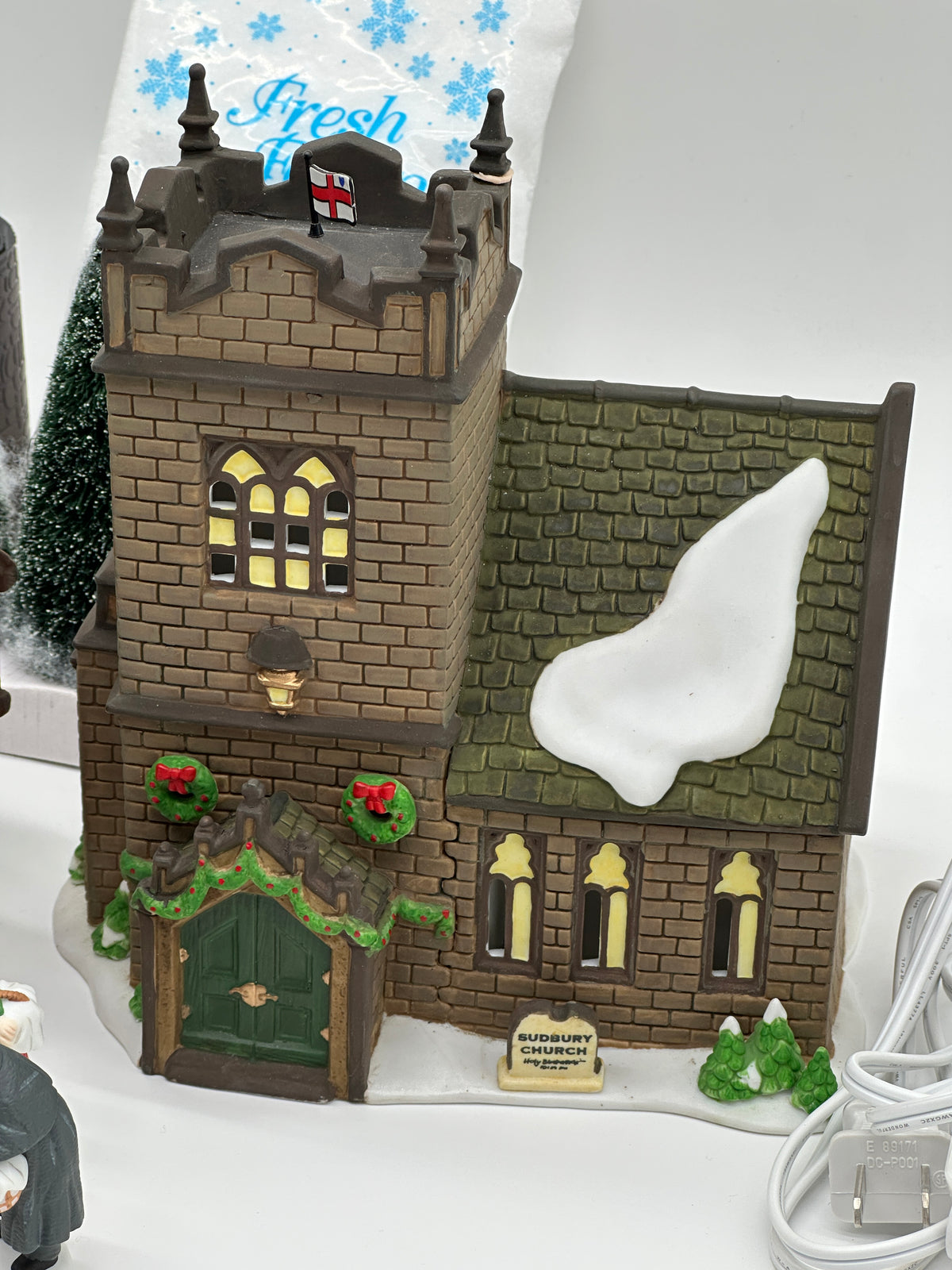 Sudbury Church, lighted stone church with square tower and wreaths over the green door, Department 56 Dickens' Village